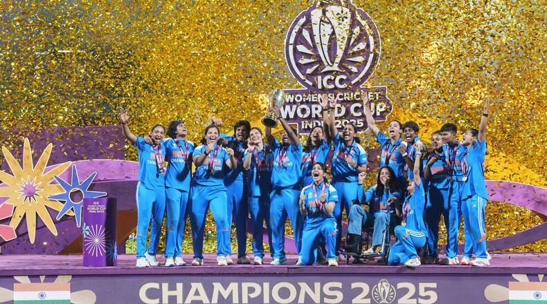 Indian players celebrate with the trophy after their win over South Africa in the ICC Women's Cricket World Cup final match in Navi Mumbai, India, Sunday, Nov. 2, 2025. (AP Photo/Rafiq Maqbool)