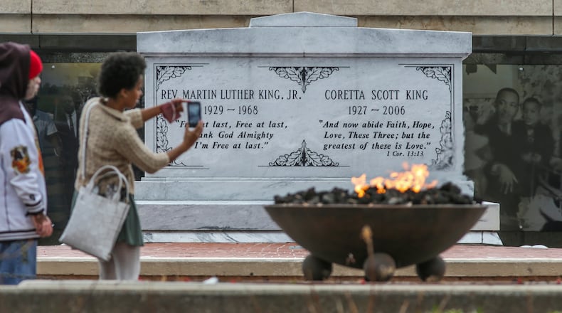 January 12, 2017 Atlanta: Alvin Sims (left) and Brandi Chapel (right) were part of a group from WOW In-Sync that visited the cryptÊof Dr. and Mrs. King, Eternal Flame, Freedom Walkway and Reflecting Pool Thursday, Jan. 12, 2017 at the King Center at 449 Auburn Ave NE, in Atlanta. Visitors to civil rights destination sites and programs in Atlanta are on the increase before the federal holiday. In Atlanta, the birthplace of the civil rights activist, there are numerous ways to acknowledge the upcoming federal holiday. Ebenezer Baptist Church, where King once served as co-pastor, will once again memorialize its most famous member during an annual celebration on Martin Luther King Jr. Day. The Martin Luther King Jr. commemorative service,  coming just days before Donald TrumpÕs inauguration, will feature Vermont Sen. Bernie Sanders, to deliver a Òspecial tributeÓ at MondayÕs Ebenezer Baptist Church ceremony.ÊElsewhere, Atlanta museums will host family-friendly educational programs, and counties throughout metro Atlanta will host local parades and programs. JOHN SPINK /JSPINK@AJC.COM