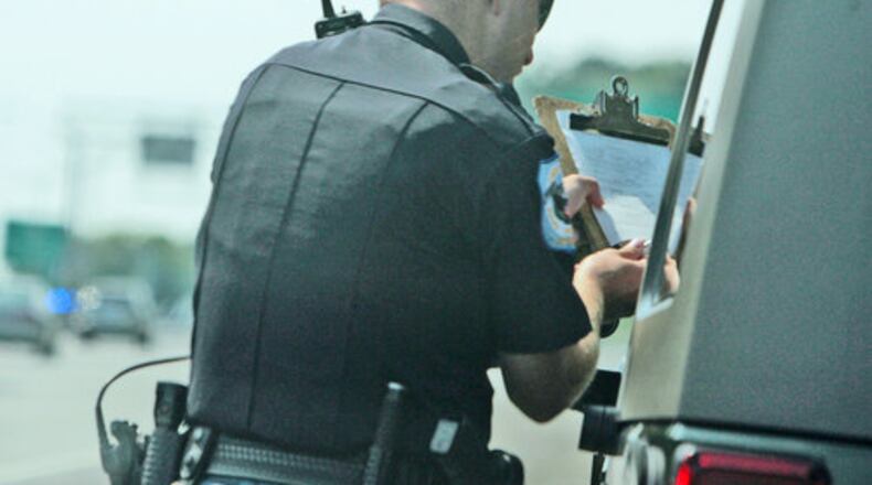 Cobb Police Officer Pete Jones tracked this individual going 78 mph, and is giving him his ticket to sign.