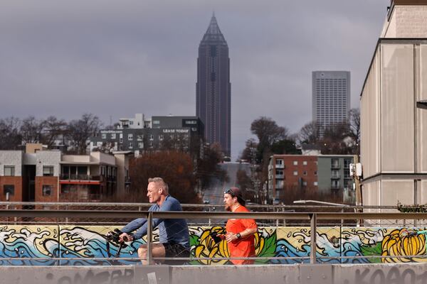 People enjoy warm weather along the Atlanta Beltline on Saturday. The temperature is in the 70s this weekend, but it will feel like winter again next week. (Natrice Miller/AJC)
