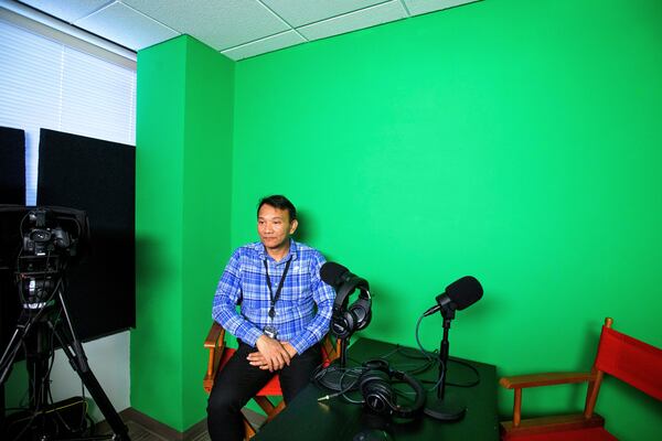 Vuthy Tha, a Cambodian reporter at Radio Free Asia who spent 7 years in a Thai refugee camp before arriving in the United States, poses for a portrait in the podcast room, Tuesday, April 1, 2025, at the RFA office in Washington. (AP Photo/Rod Lamkey, Jr.)