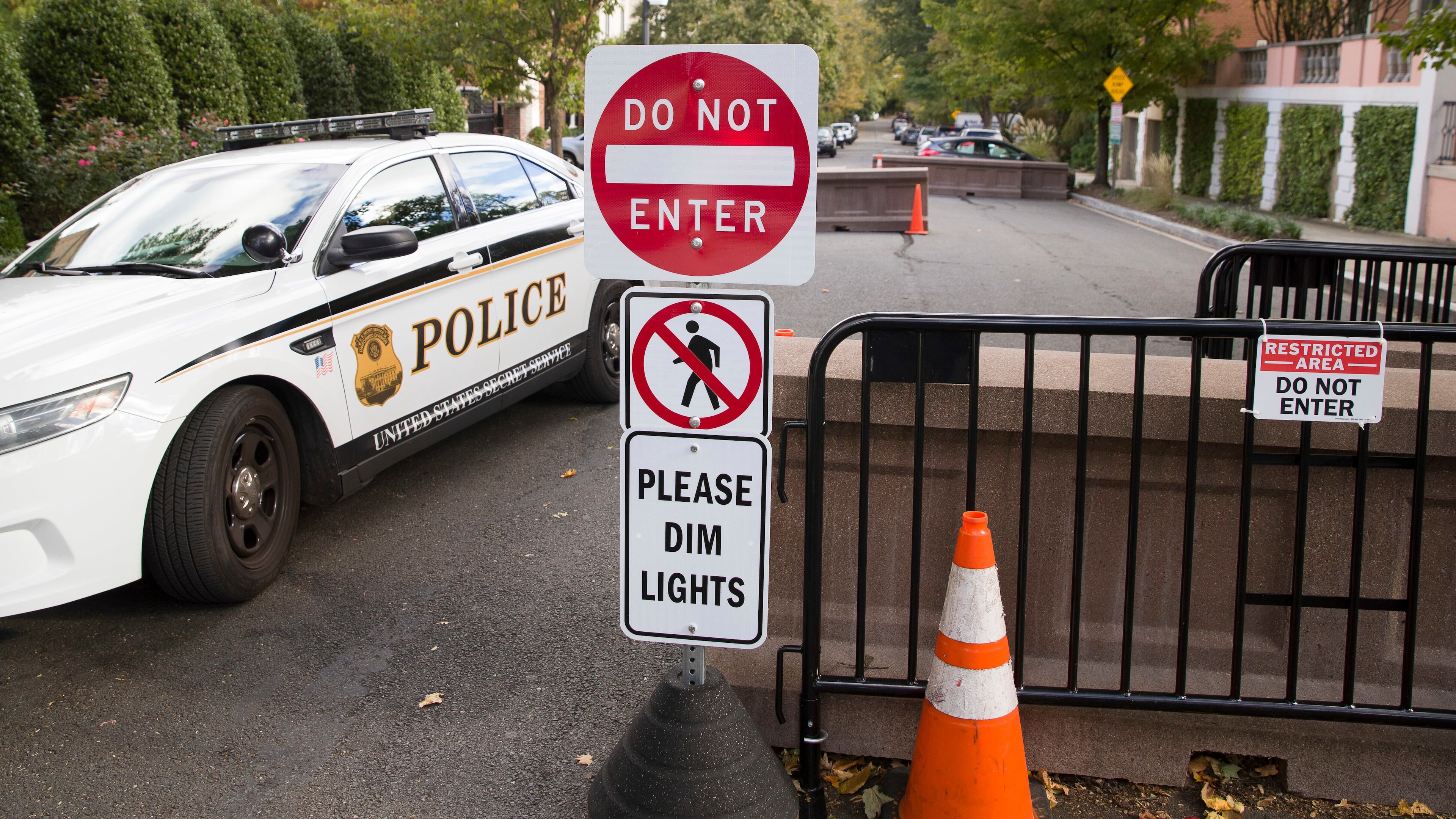 FILE - An officer with the Uniform Division of the United States Secret Service sits in his car at a checkpoint near the home of President Barack Obama, Oct. 24, 2018, in Washington.  (AP Photo/Alex Brandon, File)