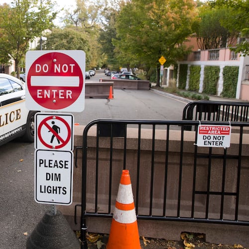 FILE - An officer with the Uniform Division of the United States Secret Service sits in his car at a checkpoint near the home of President Barack Obama, Oct. 24, 2018, in Washington.  (AP Photo/Alex Brandon, File)