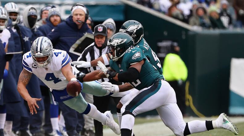 Quarterback Dak Prescott (4) is run out of bounds by Eagles linebackers Mychal Kendricks (95) and Najee Goode (52) during the first half of the game at Lincoln Financial Field on December 31, 2017 in Philadelphia. CREDIT: Elsa/Getty Images