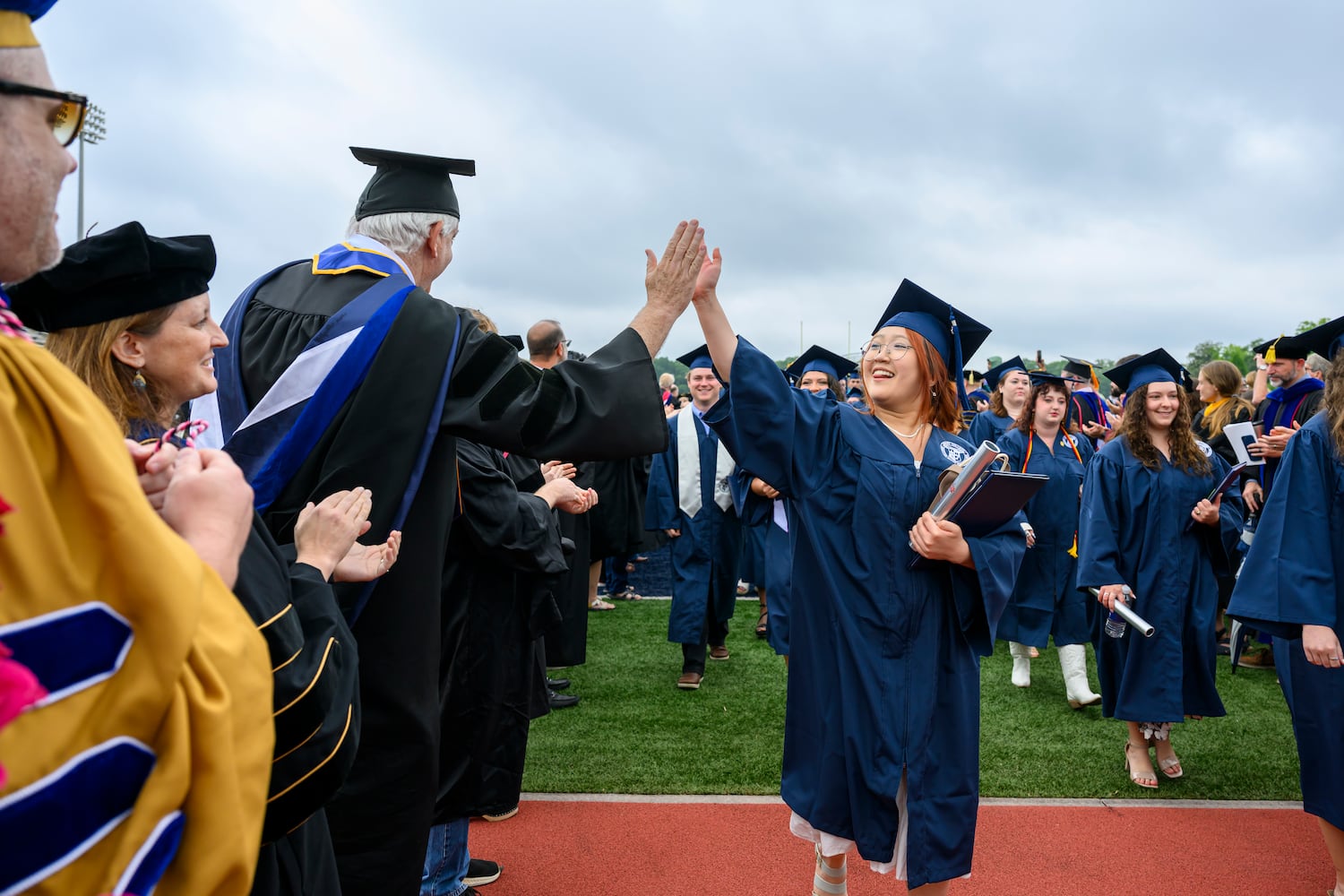 Berry College graduate Hannah Hwang is congratulated by John Grout, department chair of management and entrepreneurship, during commencement Saturday, May 9, 2026. The nationally recognized Georgia college is located on a  campus encompassing more than 27,000 acres in Rome, Ga. (Brant Sanderlin/Berry College)