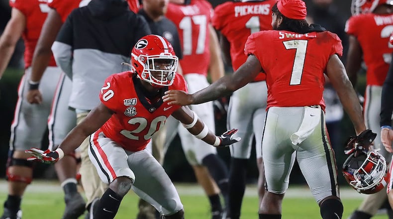 Georgia defensive back J.R. Reed (left) celebrates stopping Missouri on fourth down with tailback D'Andre Swift (right) to take over on downs in the final minutes of the fourth quarter and preserve a 27-0 shutout over Missouri on Saturday, November 9, 2019, in Athens. Curtis Compton/ccompton@ajc.com
