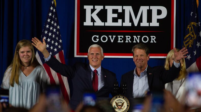 Vice President Mike Pence and  Secretary of State Brian Kemp talk at a rally in Macon GA Saturday, July 21, 2018. Vice President Mike Pence endorsed Brian Kemp for Governor during the event. STEVE SCHAEFER / SPECIAL TO THE AJC