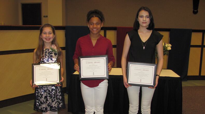 From left to right: Fifth-grader Jessica Elizabeth Stanhouse, eighth-grader Ashley Paige Richardson and high school senior Michelle Derewitz are the first recipients of the Gwinnett County school district's Caring Awards. Photo Credit: Gwinnett County Public Schools.