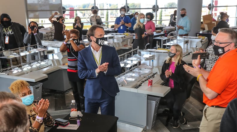 Fulton elections head Richard Barron is applauded by workers on Thursday, Nov. 5, 2020 counting ballots at State Farm Arena. Fulton County officials say election workers have completed processing absentee-by-mail ballots. Fulton elections head Richard Barron said that 145,748 absentee-by-mail ballots have been processed. Of that, he said, results of 138,000 have been posted online and 1,200 more absentees that required more signature verification will come later today — meaning there’s a difference of roughly 7,000 between what’s been processed and what’s been posted. There are still 3,600 provisional ballots and an undetermined amount of military overseas ballots left to be finalized. The deadline for those is 5 p.m. Friday. (John Spink / John.Spink@ajc.com)