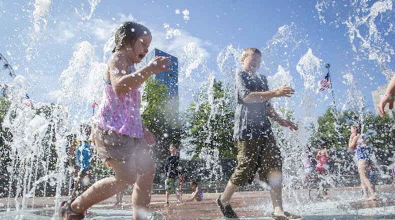 Children play in the fountain at Centennial Olympic Park. Bank of America announced Thursday a $1 million donation to expand and update the 21-acre downtown greenspace.