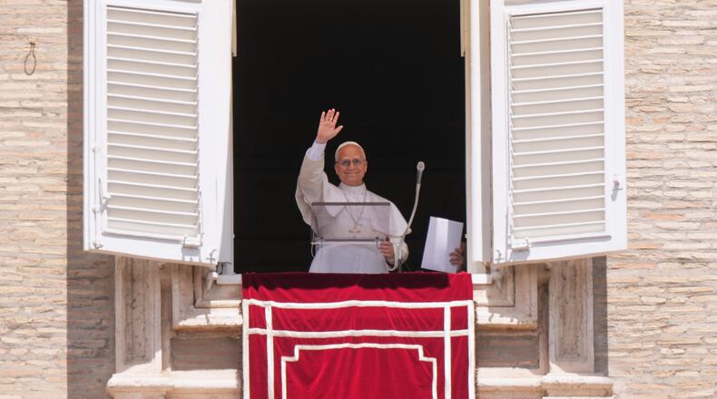 Pope Leo XIV delivers his blessing as he recites the Regina Coeli noon prayer from the window of his studio overlooking St. Peter's Square, at the Vatican, Sunday, May 17, 2026. (AP Photo/Andrew Medichini)