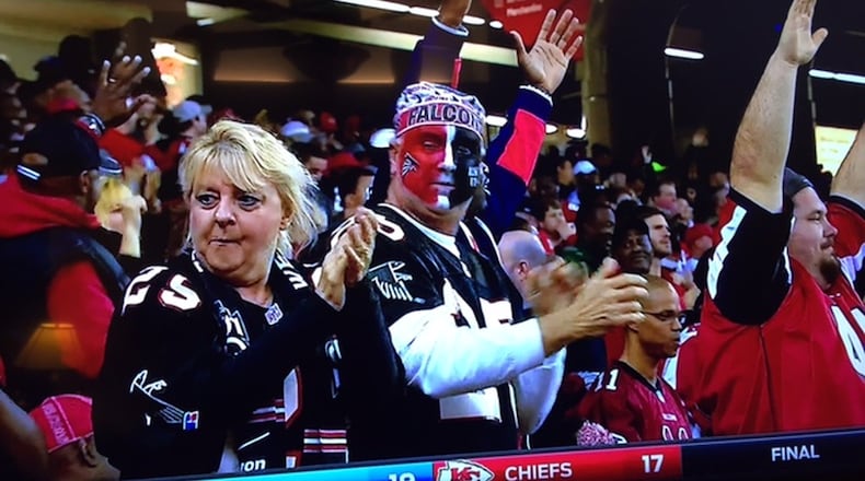 Long-time Atlanta Falcons season ticket holders Nancy Chapman, left, and Mark Chapman shown on television after a Falcons touchdown during a game earlier this season against San Francisco. Photo submitted by Clay Hall.