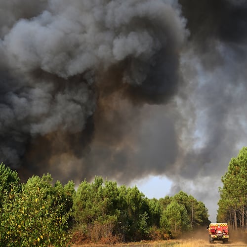 A smoke cloud rises as firefighters work to extinguish a fire in the forest near Blagon, during wildfires in southwestern France, Wednesday, July 29, 2026. (AP Photo/Emma Da Silva)