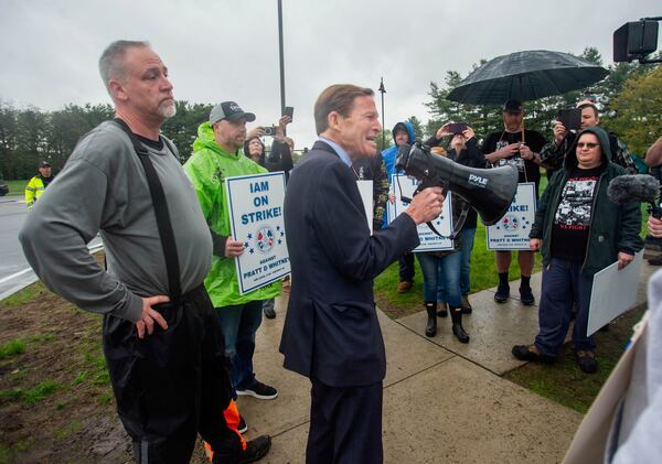 U.S. Sen. Richard Blumenthal, D-Conn., offers words of encouragement to striking Pratt & Whitney employees at the Silver Lane entrance in East Hartford, Conn., on the first day of their strike, Monday, May 5, 2025. (Aaron Flaum/Hartford Courant via AP)