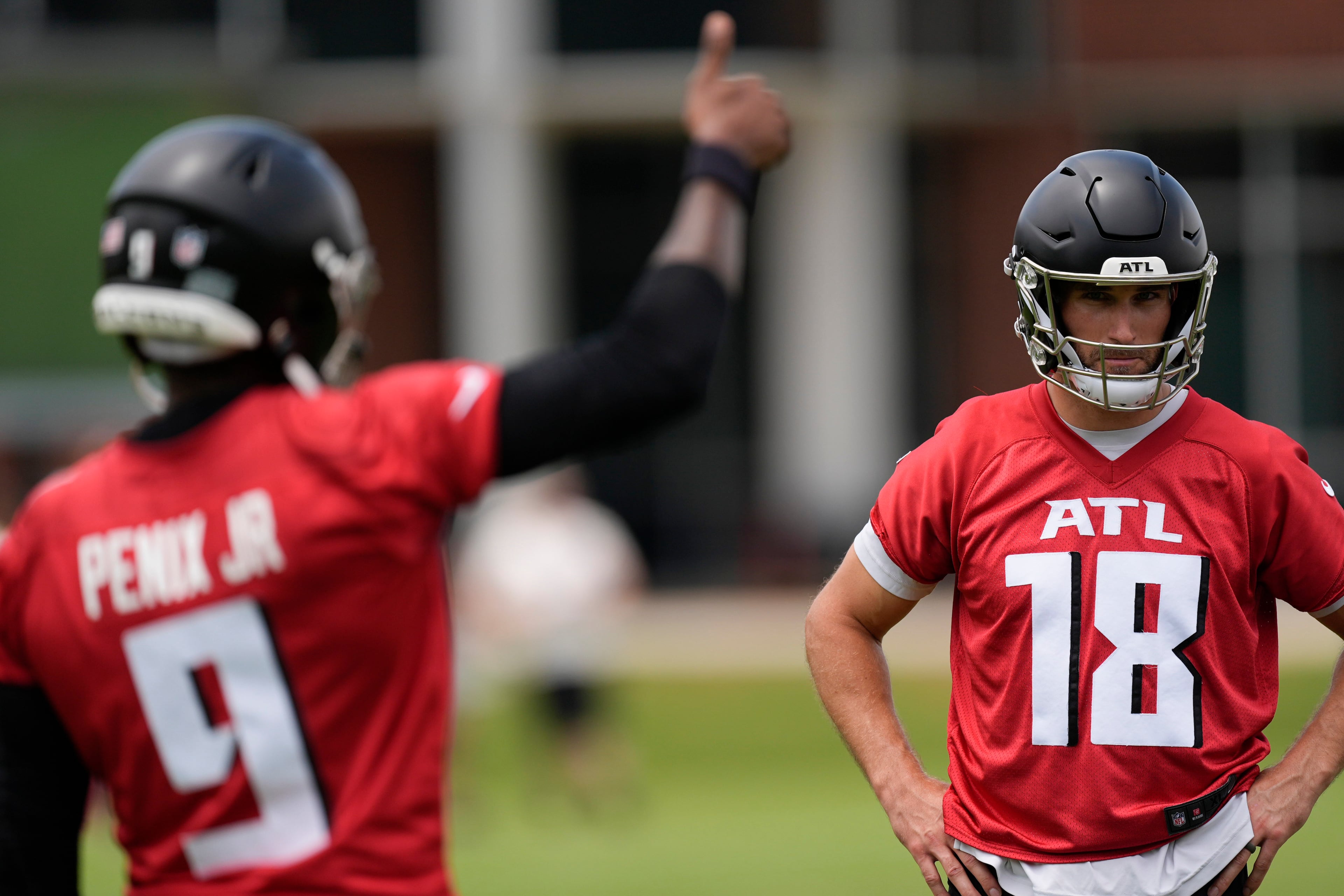 Atlanta Falcons quarterback Kirk Cousins (right) and quarterback Michael Penix Jr., work out during practice at NFL football minicamp, Tuesday, in Flowery Branch. (Mike Stewart/AP)