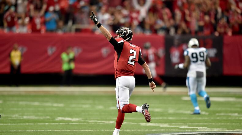 Falcons quarterback Matt Ryan celebrates after connecting with wide receiver Julio Jones for a 75-yard touchdown against the Carolina Panthers in the Georgia Dome Sunday. The Falcons won behind Ryan’s 503 passing yards and Jones’ 300 receiving yards, both franchise records. (Brant Sanderlin / bsanderlin@ajc.com)