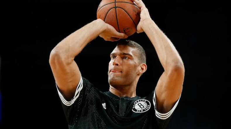 Brooklyn Nets center Brook Lopez shoots before an NBA preseason basketball game against the Detroit Pistons in Auburn Hills, Mich., Thursday, Oct. 8, 2015. (AP Photo/Paul Sancya)