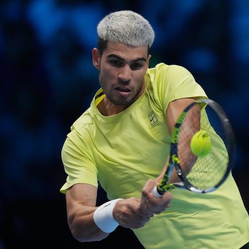 Spain's Carlos Alcaraz returns the ball to Italy's Lorenzo Musetti during their singles tennis match of the ATP World Tour Finals, in Turin, Italy, Thursday, Nov. 13, 2025. (AP Photo/Antonio Calanni)