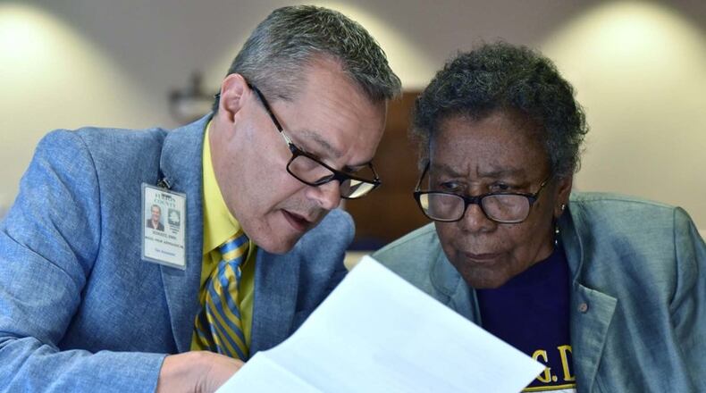 Emil Schultz (left), appraiser, helps Fulton County resident Marie F. Blake with her annual notice of assessment during an emergency town hall meeting earlier this month. Hyosub Shin/AJC