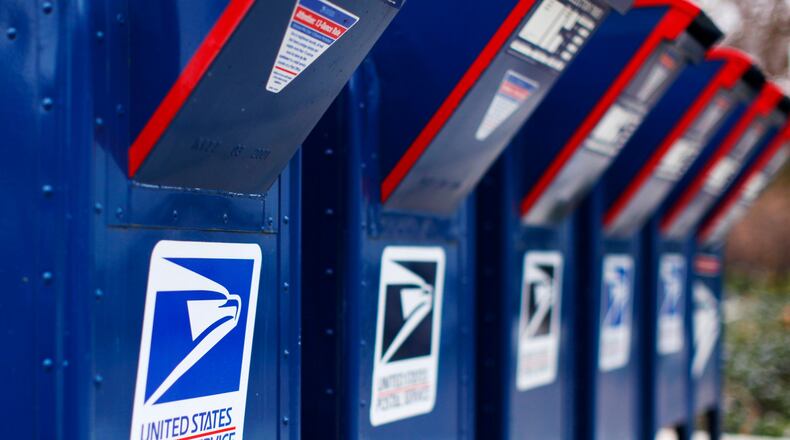 Sixteen U.S. Postal Servies workers in metro Atlanta were sentenced for delivering cocaine in exchange for bribes.