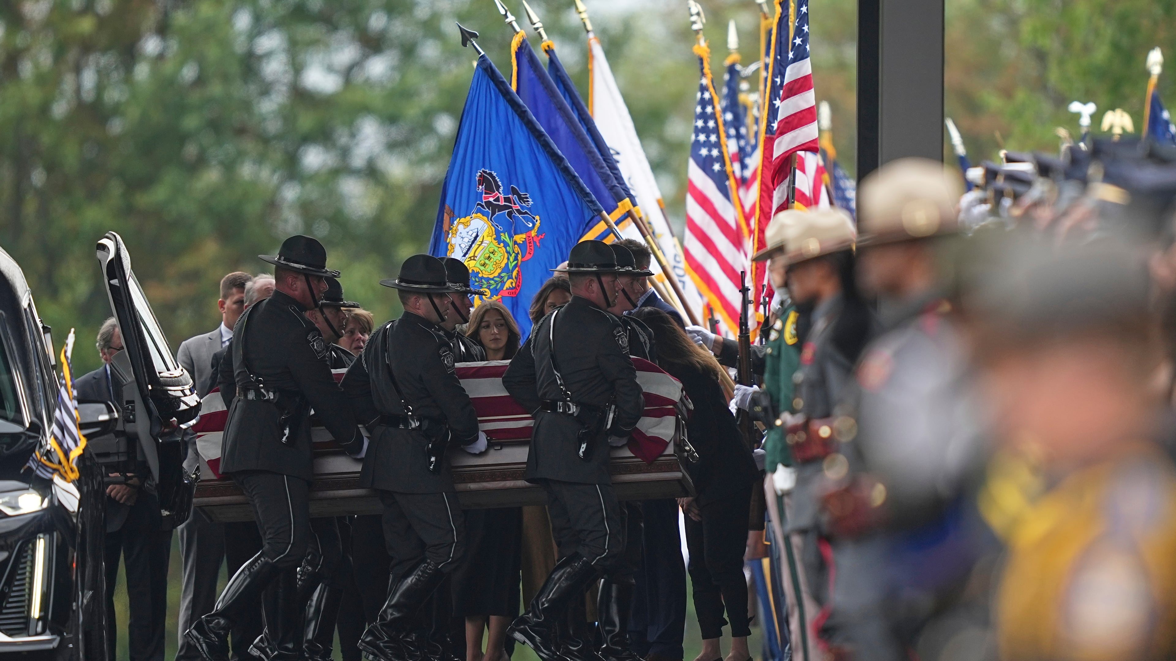 Pall bearers carry the coffin of a slain officer during funeral services for Northern York County Regional Police detectives Cody Michael Becker, Mark Edward Baker and Isaiah Emenheiser, Thursday, Sept. 25, 2025, in Red Lion, Pa. (AP Photo/Matt Rourke)