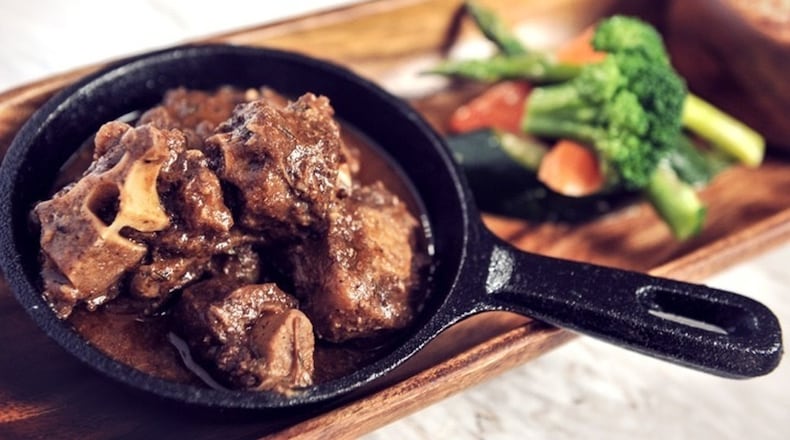 This oxtail stew is served in a personal-size skillet. Contributed by Negril Village Atlanta.