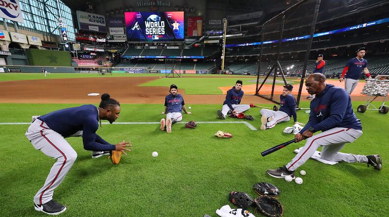Infielders Ozzie Albies (from left), Dansby Swanson, Austin Riley and Freddie Freeman work with coach Ron Washington before playing the Astros in Game 1 of the 2021 World Series. As much as the players learn from Washington, he learns from them. (Curtis Compton / Curtis.Compton@ajc.com)