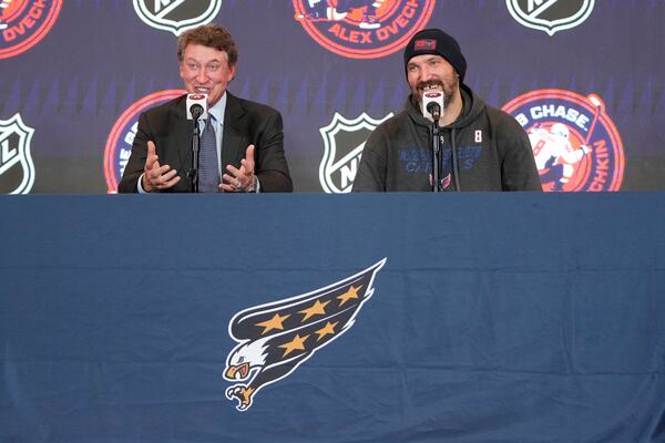 Former NHL player Wayne Gretzky, left, with Washington Capitals Alex Ovechkin, right, during a press conference after an NHL hockey game in which Ovechkin tied Gretzky's NHL career goals record of 894th goals, Friday, April 4, 2025, in Washington.(AP Photo/Mark Schiefelbein)