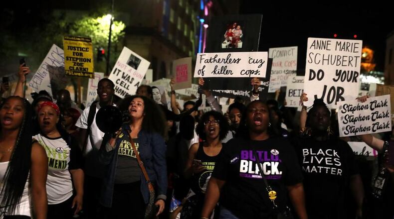 Citizens carried signs during a vigil for Stephon Clark.