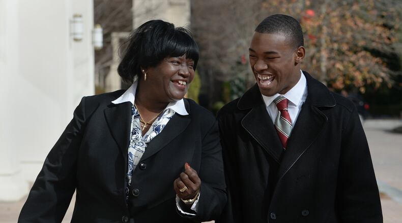 Academic coach Mary Palmer and her student athlete Jerome Smith on Friday, December 27,2013, outside the Chick-fil-A Bowl headquarters. The Chick-fil-A Bowl pays for 10 academic coaches who tutor and mentor students in every Atlanta public high school, and the bowl also distributes $200,000 a year for scholarships at schools that play in the annual college football game.