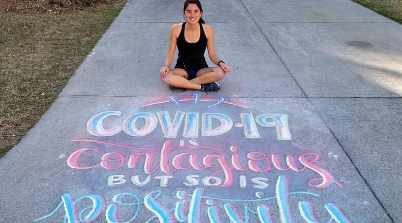 Joyce Wilmot with her chalk art entry to win one of Suwanee's 2020 Spring Break T-shirts. (Courtesy City of Suwanee)