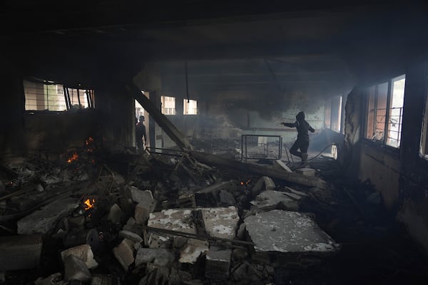 Palestinians inspect the damage after an Israeli airstrike early this morning on Yaffa School, in Gaza City, Wednesday, April 23, 2025. (AP Photo/Jehad Alshrafi)