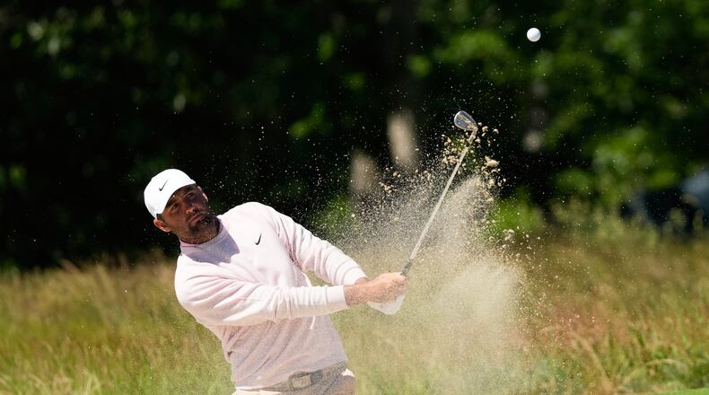 Scottie Scheffler hits from the bunker on the second hole during a practice round for the U.S. Open golf tournament at Shinnecock Hills Golf Club in Southampton, N.Y., Tuesday, June 16, 2026.(AP Photo/David J. Phillip)