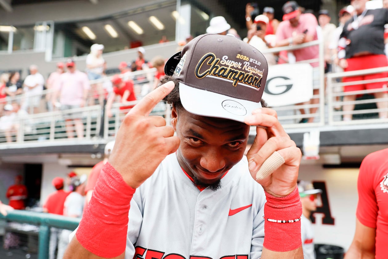 Georgia infielder Ryan Wynn points at his championship hat as he celebrates with his team after winning an NCAA super regional against Mississippi State at Foley Field on Sunday, June 7, 2026, in Athens. (Miguel Martinez/AJC)