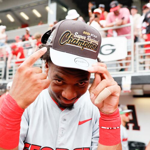 Georgia infielder Ryan Wynn points at his championship hat as he celebrates with his team after winning an NCAA super regional against Mississippi State at Foley Field on Sunday, June 7, 2026, in Athens. (Miguel Martinez/AJC)
