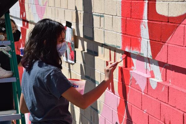 North Gwinnett High School student Clarissa Reizenson paints part of the Chinese zodiac mural. (Courtesy of Curt Yeomans)
