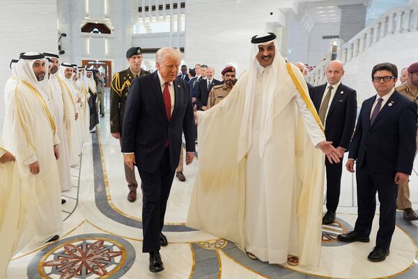 Qatar's Emir Sheikh Tamim bin Hamad Al Thani welcomes President Donald Trump during an official welcoming ceremony at the Amiri Diwan in Doha, Qatar, Wednesday, May 14, 2025. (AP Photo/Alex Brandon)
