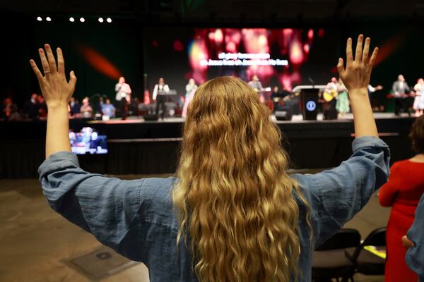 A messenger attending the Southern Baptist Convention participates in worship during the 2025 SBC Annual Meeting, Tuesday, June 10, 2025, in Dallas. (AP Photo/Richard W. Rodriguez)