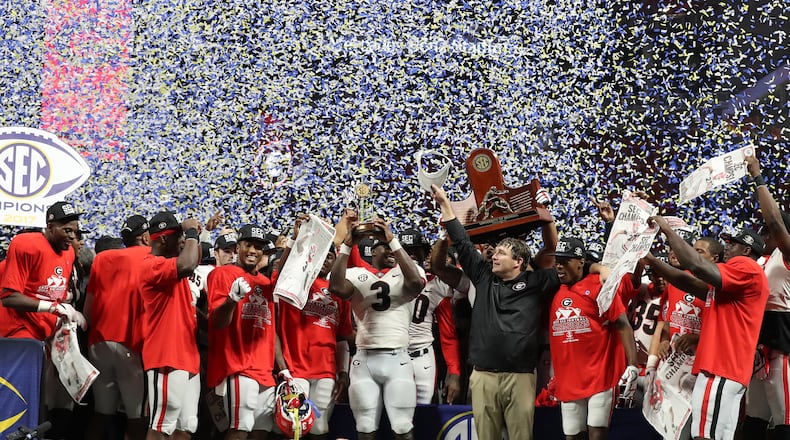 December 2, 2017 Atlanta: Georgia Bulldogs linebacker Roquan Smith (3), head coach Kirby Smart, and Georgia teammates celebrate after defeating the Auburn Tigers 28-7 during the SEC Football Championship at Mercedes-Benz Stadium, December 2, 2017, in Atlanta.  Curtis Compton / ccompton@ajc.com