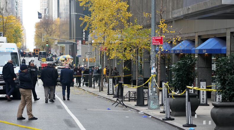 Crime Scene Unit police photograph the scene where the CEO of UnitedHealthcare Brian Thompson, 50, was shot as he entered the New York Hilton early on Dec. 4, 2024. (Bryan R. Smith/AFP/Getty Images/TNS)