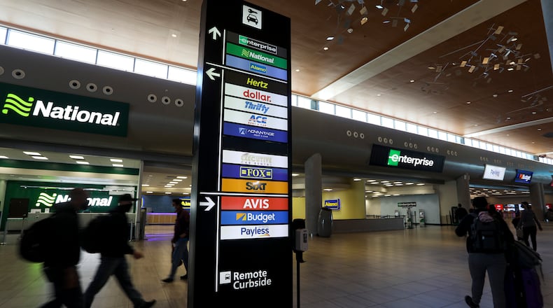 Travelers walk inside Tampa International Airport's Rental Car Center. Battered by the COVID-19 pandemic, rental car companies are facing a national car shortage, causing availability for travelers to plummet and daily rental rates to spike to as high as nearly $500 a day in Tampa. (Ivy Ceballo/Tampa Bay Times/Zuma Press/TNS)