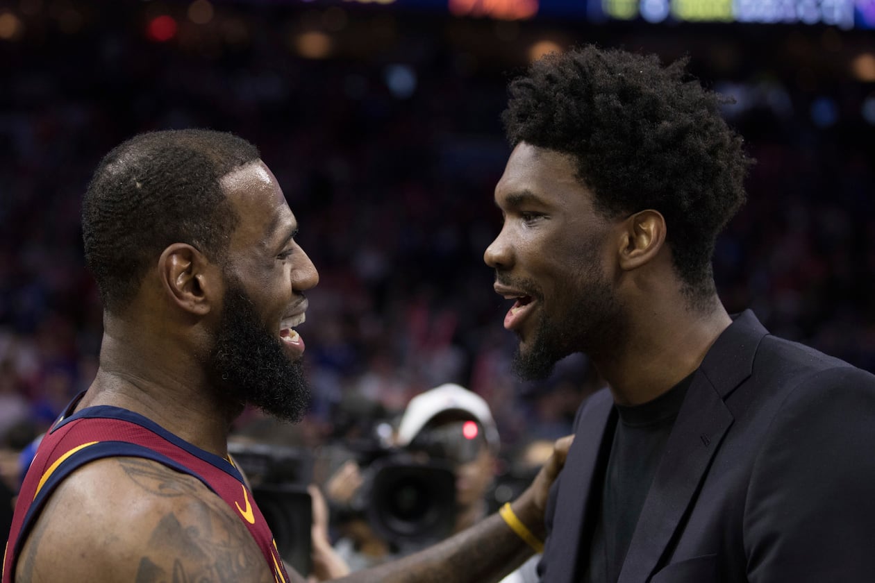 FILE - Cleveland Cavaliers' LeBron James, left, talks with Philadelphia 76ers' Joel Embiid, right, of Cameroon, after the second half of an NBA basketball game, April 6, 2018, in Philadelphia. (AP Photo/Chris Szagola, File)