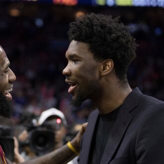 FILE - Cleveland Cavaliers' LeBron James, left, talks with Philadelphia 76ers' Joel Embiid, right, of Cameroon, after the second half of an NBA basketball game, April 6, 2018, in Philadelphia. (AP Photo/Chris Szagola, File)