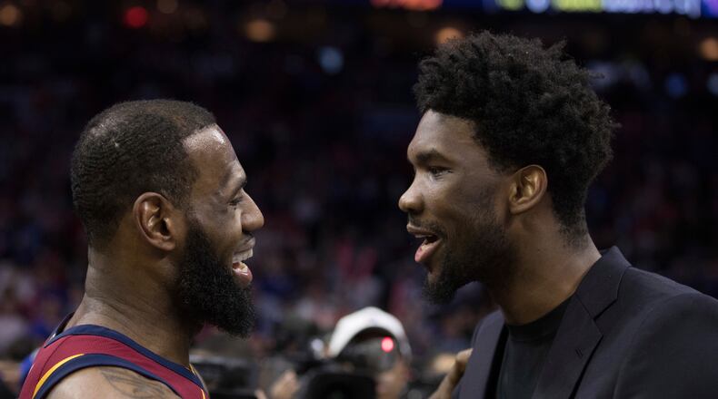 FILE - Cleveland Cavaliers' LeBron James, left, talks with Philadelphia 76ers' Joel Embiid, right, of Cameroon, after the second half of an NBA basketball game, April 6, 2018, in Philadelphia. (AP Photo/Chris Szagola, File)