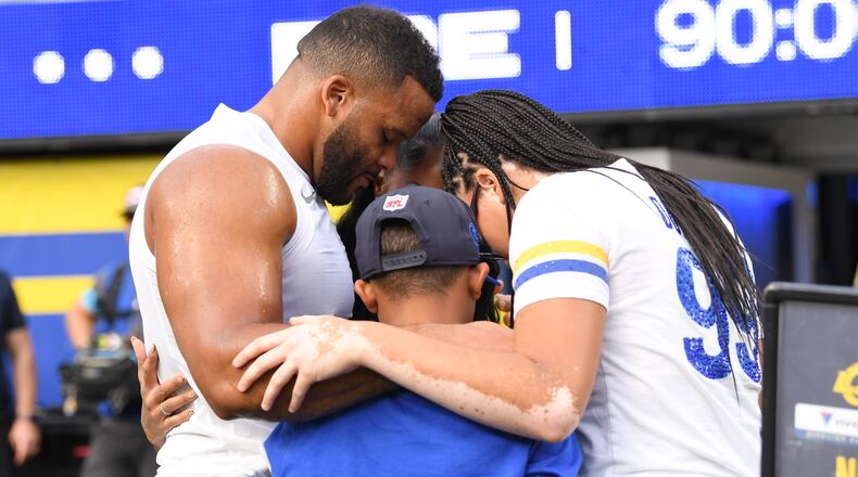Los Angeles Rams defensive end Aaron Donald huddles with his family before an NFL football game against the New York Giants in Inglewood, Calif., Monday, Sept. 21, 2026. (AP Photo/Katie Chin)