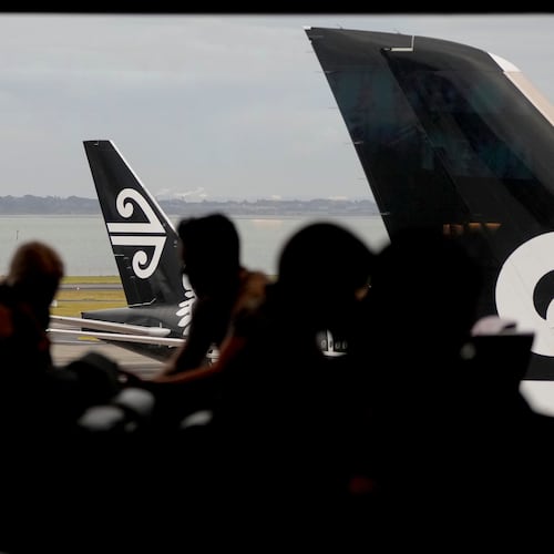FILE -Passengers wait in the Air New Zealand lounge at Auckland International Airport in Auckland, New Zealand, Wednesday, March 23, 2022.(AP Photo/Mark Baker, File)