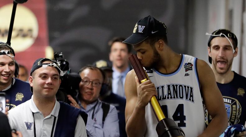 Villanova's Omari Spellman kisses the championship trophy as he walks to the locker room after the championship game of the Final Four. The Hawks selected Spellman with the No. 30 overall pick in the NBA draft last month.