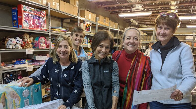 Community Assistance Center Adopt-a-Family volunteers have been working hard taking in donations, organizing gifts and distributing to families. (Courtesy Community Assistance Center)