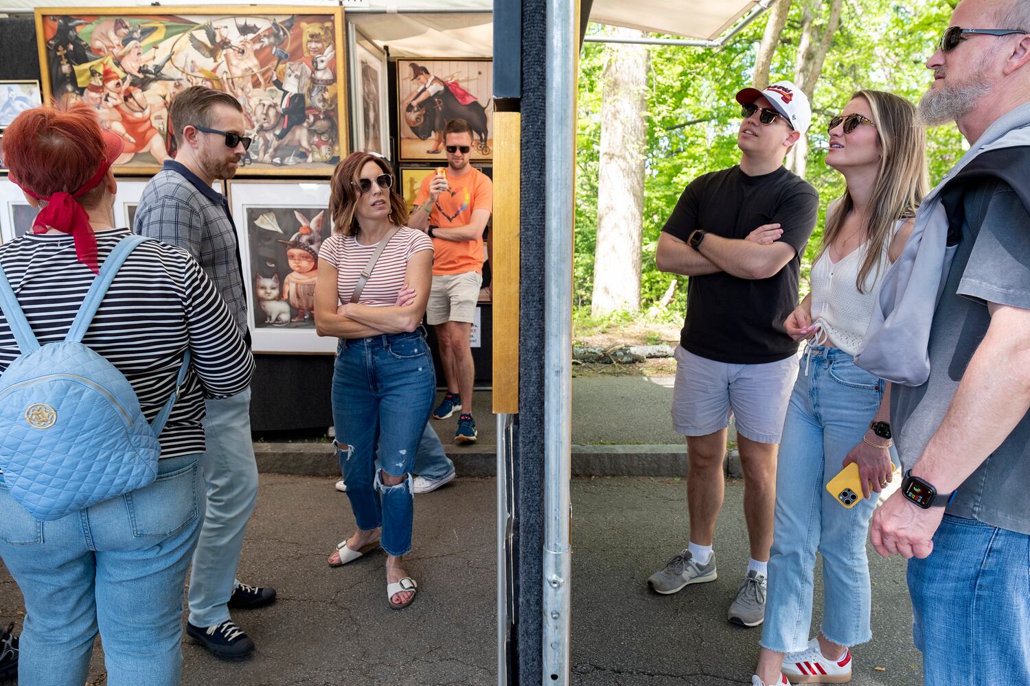 People view the work of Phoenix artist Tanya Doskova at her booth during the Dogwood Festival in Piedmont Park on Saturday, April 13, 2024.   (Ben Gray / Ben@BenGray.com)