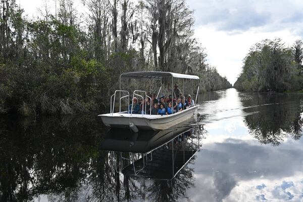 Visitors enjoy a boat tour the Okefenokee Swamp, Monday, Mar. 18, 2024, in Folkston. (Hyosub Shin/AJC)